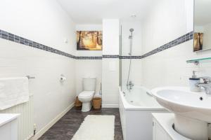a white bathroom with a sink and a toilet at Hidden Gem 2BR flat wBalcony near Surrey Quays in London