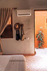 a bedroom with a bed and a window and a plant at Las Dunas Beach Guest House in Juan de Acosta