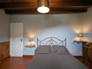 a bedroom with a bed with two lamps on the wall at Gîte familial près de Nohant avec jardin, cheminée, garage et WIFI gratuit - FR-1-591-94 in Nohant-Vic