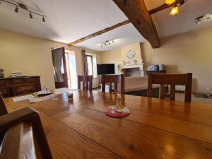 a dining room with a large wooden table with chairs at Gîte Prissac, 2 pièces, 4 personnes - FR-1-591-99 in Prissac