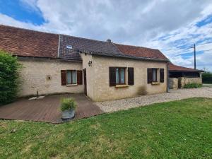 a house with a wooden deck in front of it at Maison paisible avec jardin clos, terrasse, proche lac d'Eguzon et villages médiévaux - FR-1-591-102 in Vigoux