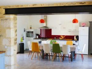 a kitchen with a dining table and chairs at Gîte rénové avec jardin clos, proche plages, Wifi, parking pour voiture électrique - FR-1-426-164 in Le Bernard