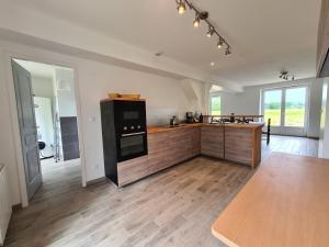 a kitchen with black appliances and a wooden floor at Gîte Montierchaume, 4 pièces, 6 personnes - FR-1-591-359 in Montierchaume