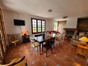 a living room with a table and chairs and a couch at Escapade Nature : Maison et Lofts Privés avec Piscine, Étang de Pêche et Grandes Terrasses - FR-1-591-365 in Bélâbre