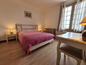 a bedroom with a bed and a desk and windows at Escapade Nature : Maison et Lofts Privés avec Piscine, Étang de Pêche et Grandes Terrasses - FR-1-591-365 in Bélâbre +20 photos
