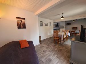 a living room with a couch and a dining room at Maison de campagne en Berry, proche de La Châtre et George Sand, cour, jardin privé, tout inclus - FR-1-591-368 in Verneuil-sur-Igneraie