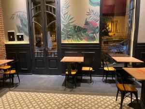 a restaurant with tables and chairs in front of a door at Andén 7 3/5 in Salta
