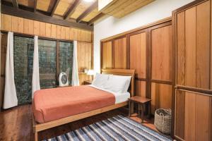 Postel nebo postele na pokoji v ubytování Kuranda Rainforest Chalet