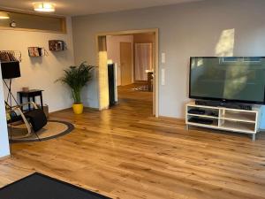 a living room with a large flat screen tv at Schönes und gemütliches Haus in mitten der Natur in Schabenhausen