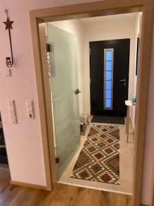 a bathroom with a glass shower and a door at Schönes und gemütliches Haus in mitten der Natur in Schabenhausen +29 photos