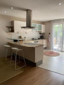 a kitchen with a island in the middle of a room at Schönes und gemütliches Haus in mitten der Natur in Schabenhausen
