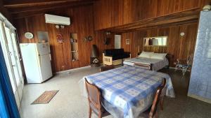 a kitchen with a table and a refrigerator in a room at Monoambiente Cañuelas Centro calle Principal hasta 4 personas in Cañuelas