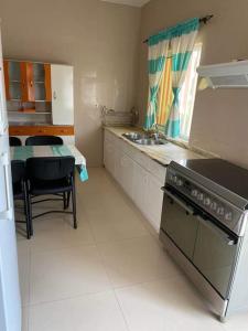 a kitchen with a sink and a stove top oven at Jbct & SOLANGE APART in Praia