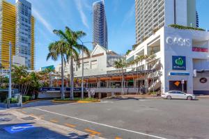 an empty street in a city with tall buildings at Island Beach Resort in Gold Coast