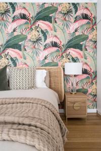 a bedroom with a bed with a floral wallpaper at Peninsula Luxury Beach House FREE WI-FI in Rosebud