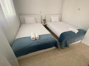 duas camas num pequeno quarto com toalhas em Central Pool-Side 2 Bedroom Apartment in Paphos em Pafos