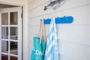 a room with blue and white towels hanging on a wall at Sorrento Beach Cottages No.1 - in the heart of Sorrento in Sorrento