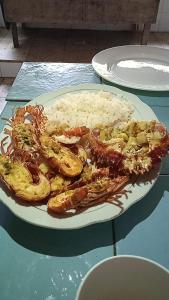 a plate of food with shrimp and rice on a table at Las Flores Econativo in Isla Grande