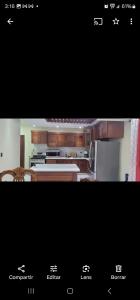 a kitchen with wooden cabinets and a white counter top at Jlp in San Francisco de Macorís