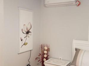 a bathroom with a flower painting on the wall at Sun Cabin #1 Pahrump in Pahrump