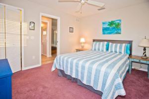 a bedroom with a bed and a desk with a lamp at Classic Floridian Oasis w/Pool in North Port +86 photos