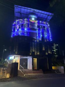 a building with blue lights on it at night at Magni Home in Cochin