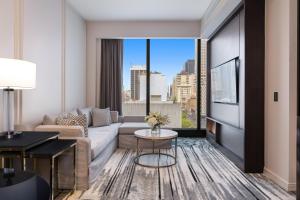 a living room with a couch and a table at Sofitel Adelaide in Adelaide