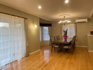 a dining room with a table and chairs at Queen Anne Style Luxury Vacation Villa in Miyota