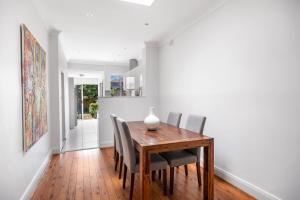 a dining room with a wooden table and chairs at WINCH9 - Seaside Serenity in Sydney