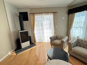 uma sala de estar com um sofá e uma lareira em Queen Anne Style Luxury Vacation Villa em Miyota