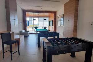 a living room with a stove and pool tables at Maravilhoso Apartamento em Brasília DF in Brasilia