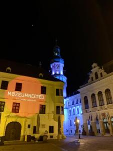 a building with a clock tower on top of it at Interno Casa in Sopron