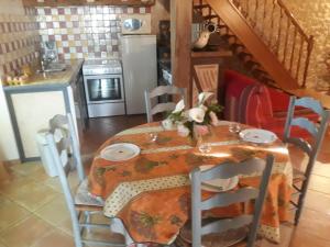 a kitchen with a table with a table cloth on it at Gîte Eymet, 3 pièces, 4 personnes - FR-1-616-247 in Eymet