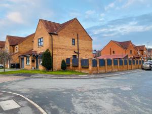 a brick house with a fence on a street at Contractors Home - 4 Bedroom Long Stays Welcome - Barnsley in Shafton