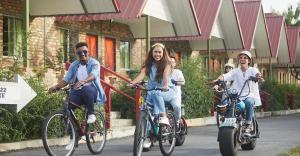 a group of people riding bikes down a street at Segar Recreation Agro Park in Port Dickson