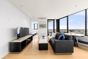 a living room with a couch and a table at Convenient Located 1bedroom apartment in St Kilda in Melbourne