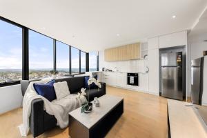 a living room with a couch and a table at Convenient Located 1bedroom apartment in St Kilda in Melbourne