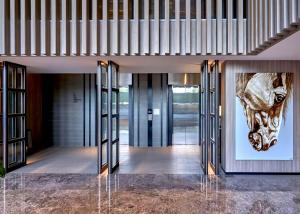 a lobby with a picture of a horse on the wall at The Park Nine Hotel Suvarnabhumi - Free BKK Airport Shuttle in Lat Krabang