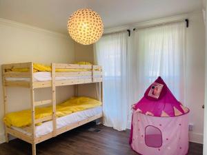a bedroom with two bunk beds and a chandelier at Chic Crosstown Bungalow with large fenced backyard in Memphis