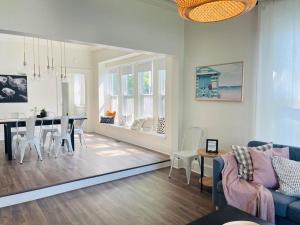 a living room with a table and a dining room at Chic Crosstown Bungalow with large fenced backyard in Memphis