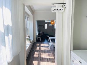 a hallway leading to a living room with a table at Chic Crosstown Bungalow with large fenced backyard in Memphis +25 photos