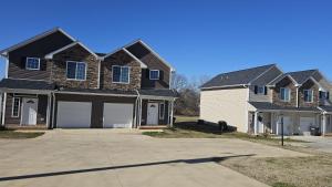 a house with a black roof and a white garage at Spacious 3-Bedroom Modern Home Near CLT Motor Speedway in Concord