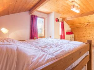 a large bed in a room with a wooden ceiling at Chalet Les Arcs 1800, 4 pièces, 8 personnes - FR-1-346-310 in Arc 1800