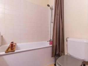 a bathroom with a white tub and a toilet at Appartement Les Arcs 1800, 4 pièces, 8 personnes - FR-1-346-321 in Arc 1800