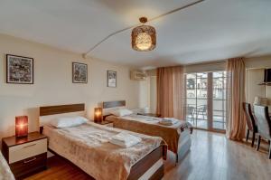 a hotel room with two beds and a window at Liva Hotel in Tbilisi City