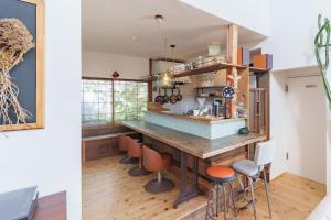 a kitchen with a large wooden table and chairs at SMALL TOWN HOTEL Hakodate in Hakodate