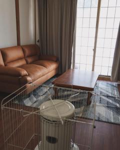 a living room with a couch and a bird cage at HAKUBA76 in Hakuba