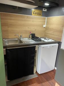 a small kitchen with a sink and a dishwasher at Saint François in Bordeaux