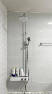 La salle de bains est pourvue d'une douche et d'une étagère. dans l'établissement Lakeside Mirinae Villa, à Anseong