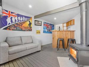 a living room with a couch and a stove at NEW! Stunning 4BR Cottage In The Heart Of Ballarat - PET FRIENDLY & FAST WIFI in Ballarat